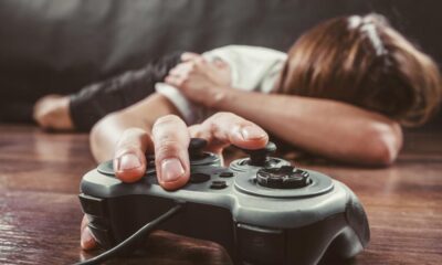 Gamer laying on the floor touching game pad