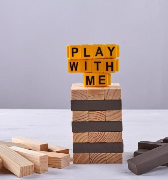 Play with me written on jenga tower