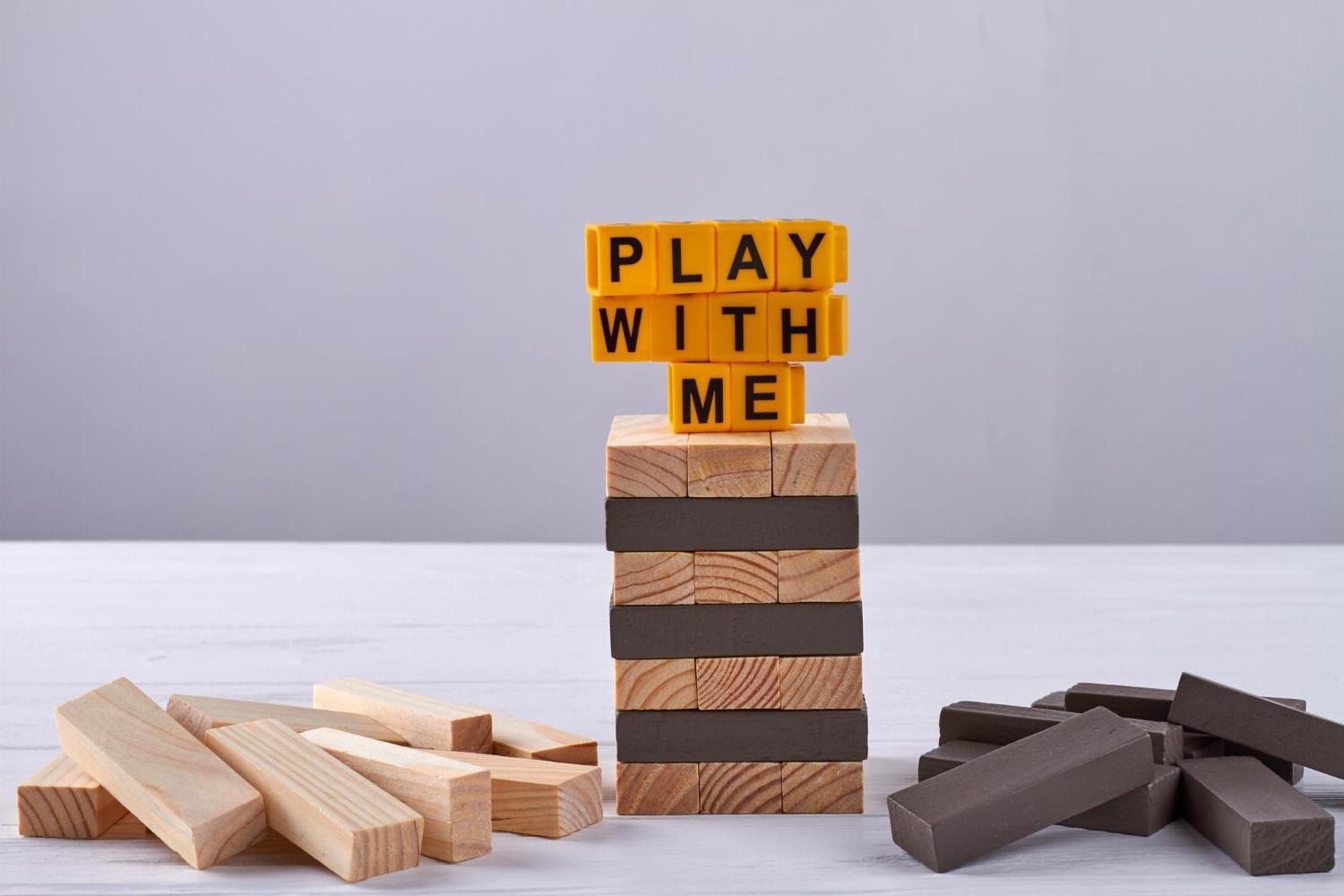 Play with me written on jenga tower