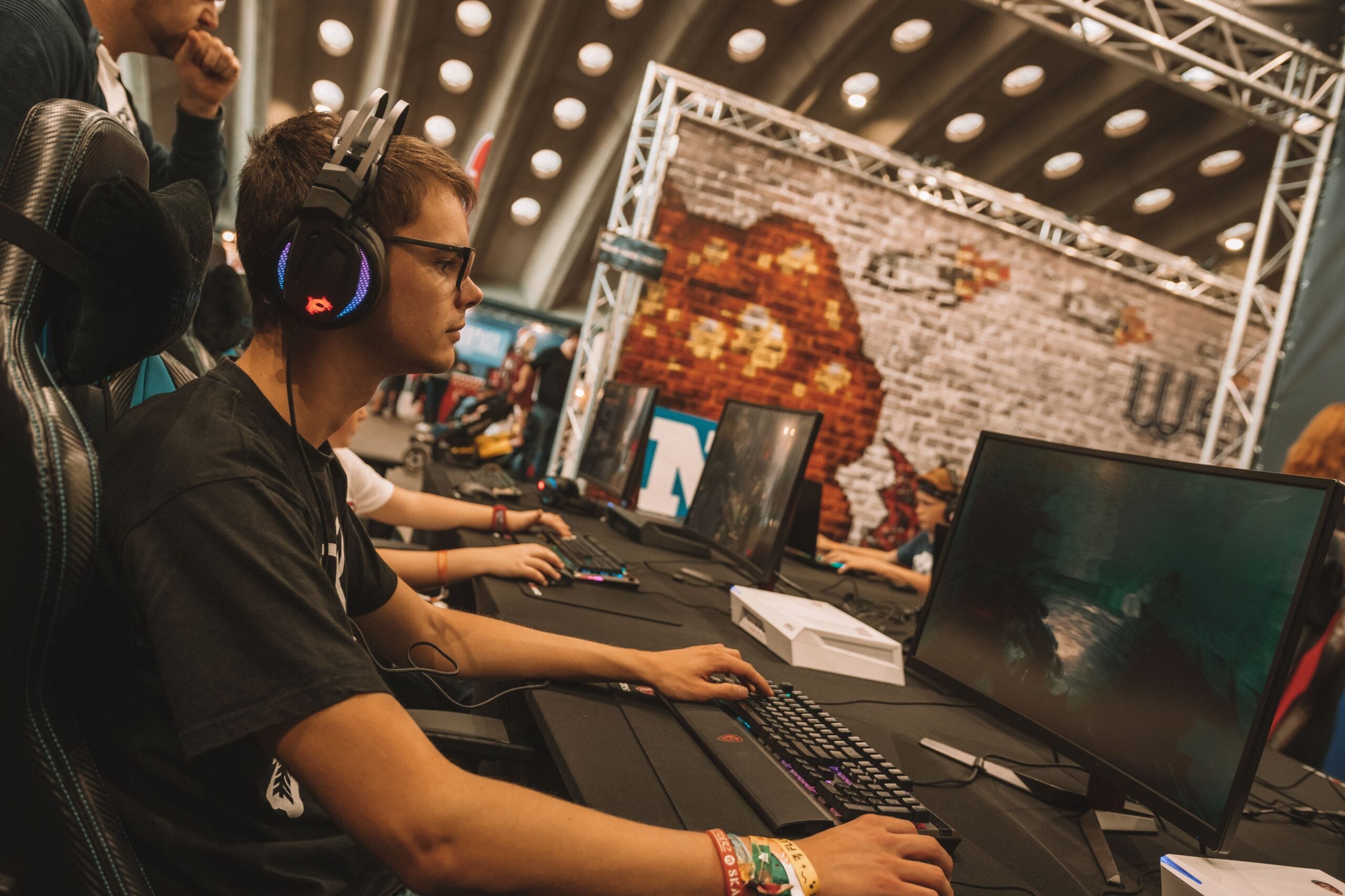 Esports player competing on a gaming PC during a live LAN tournament.