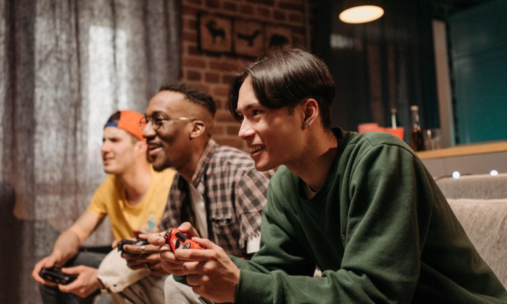 Friends playing video games on couch