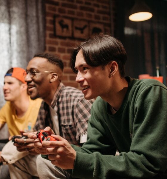 Friends playing video games on couch