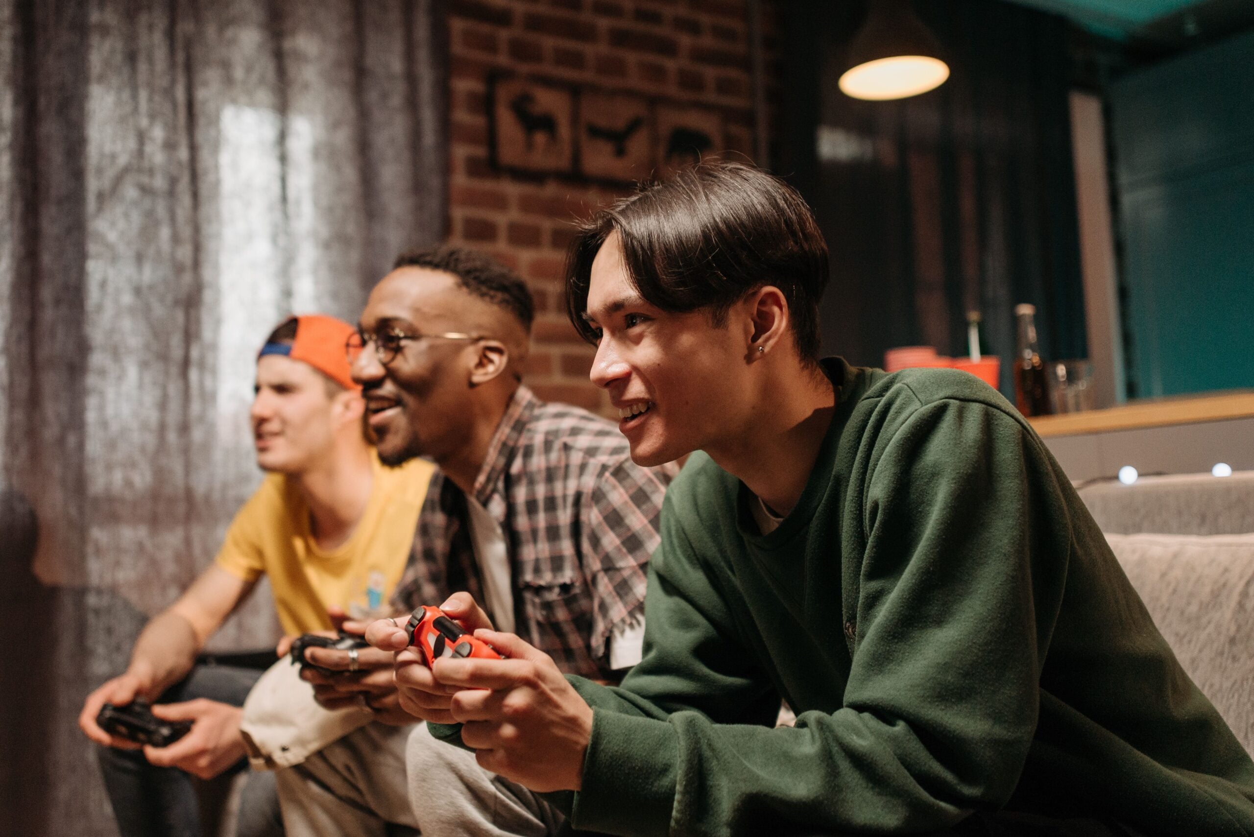 Friends playing video games on couch