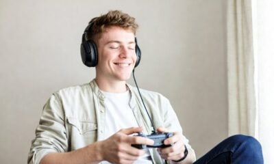 Man playing video game and listening to Music