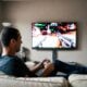 Man playing video game on sofa
