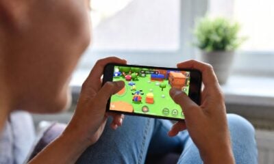 Woman playing video game on her smartphone