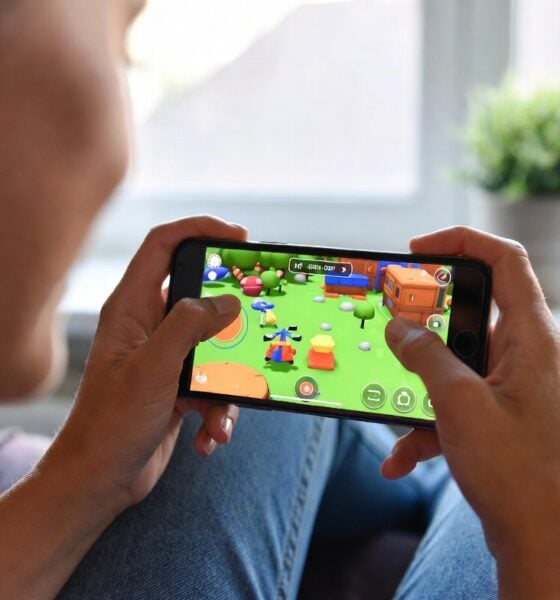Woman playing video game on her smartphone