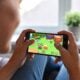 Woman playing video game on her smartphone